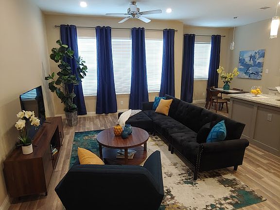 Spacious living room with 2 overhead fans