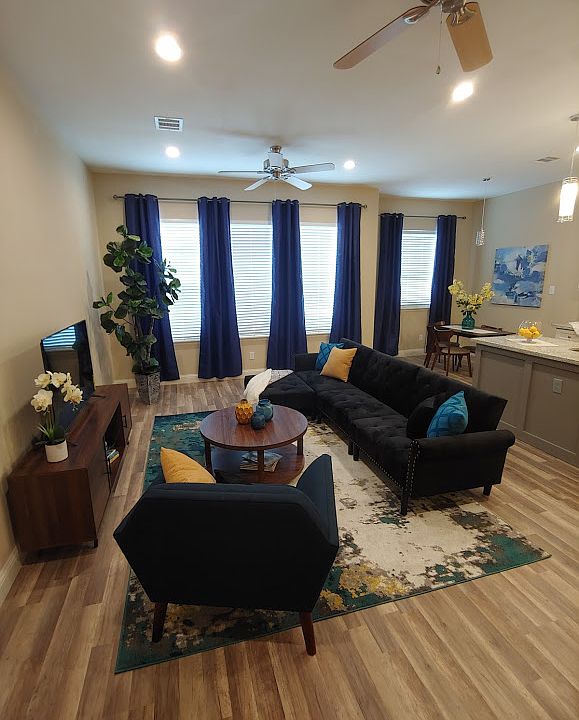 Spacious living room with 2 overhead fans