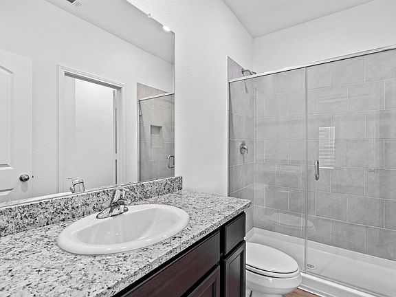 Master bathroom with a large walk-in shower lined with tile.