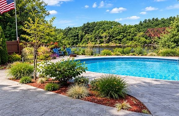 Experience resort-style living with a sparkling inground swimming pool, expansive stamped concrete patio, and beautifully landscaped surroundings. Enjoy the perfect setting for summer relaxation, outdoor entertaining, and picturesque Merrimack River!