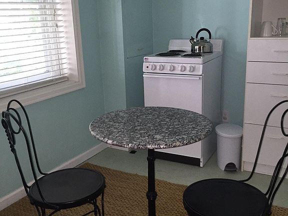 Eating area in front of large windows overlooking garden