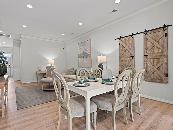 The dining room and great room in the Versailles model at The Crest at Linton Hall by Brookfield Res