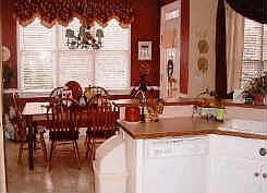Kitchen has white cabinets, lots of countersapce, pantry and oversized dining area