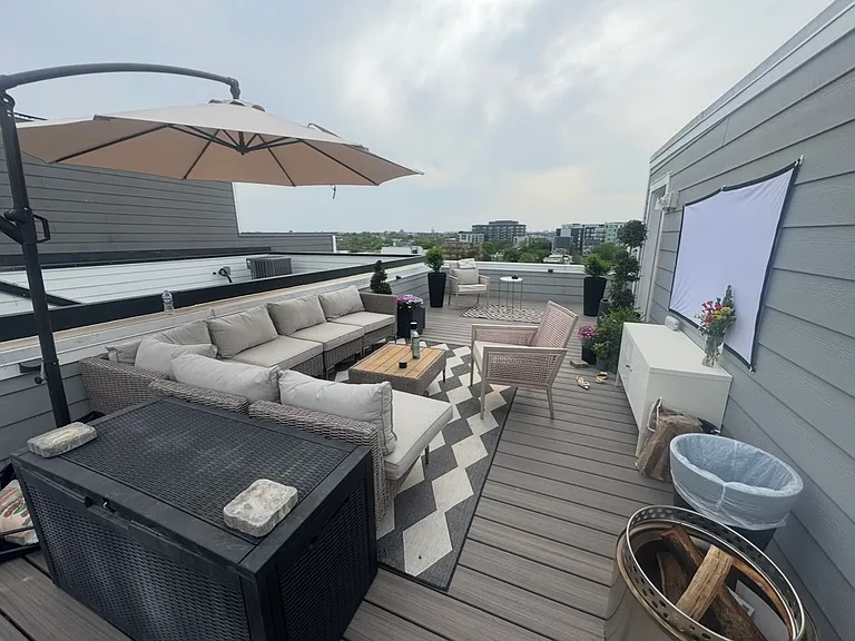 The roof deck features a large couch with seating for 5 to 7 people