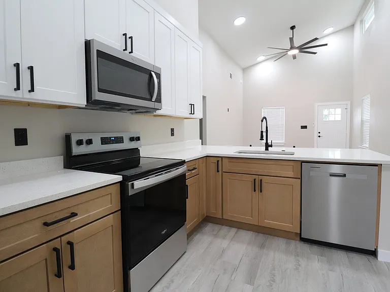 Modern kitchen featuring new stainless steel appliances, white cabinetry, and clean contemporary finishes.
Functional layout with plenty of storage.