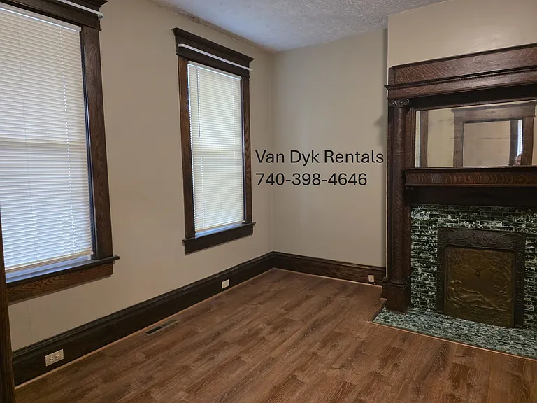 Looking into living room showing the decorative fireplace.