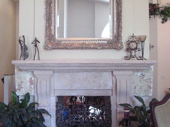 Gorgeous dual fireplace with mantel between rooms.