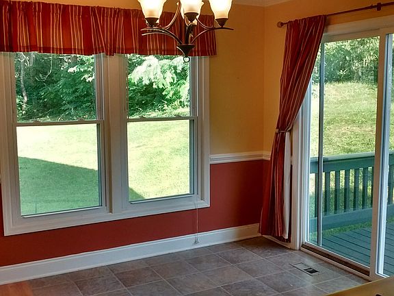 dining room without furniture - view of yard from east and south facing windows