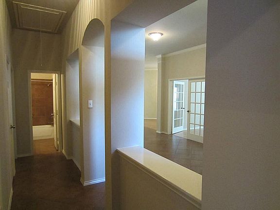 Hallway leading to all alternate bedrooms.  This is view of front entrance from front bedroom.  Notice decorative arches.
