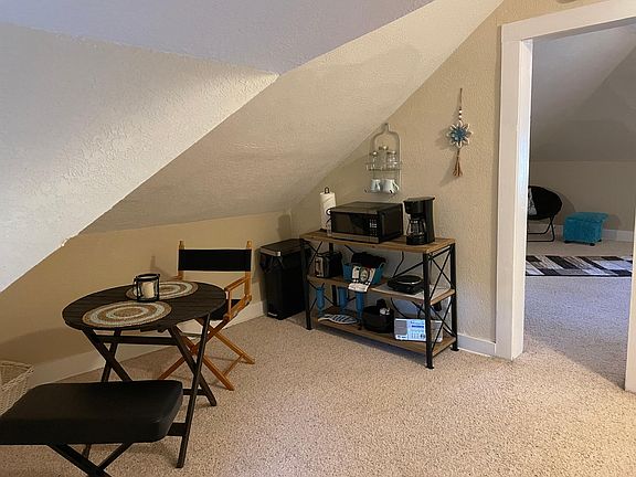 Breakfast nook at top of landing includes mini-refrigerator, microwave, coffee pot, toaster, hot plate and small table
