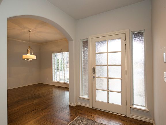 Enryway Leads to Arched Opening to Formal Dining Room