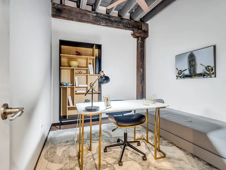 Productivity Nook: A dedicated office space adorned with art, showcasing a stylish desk setting, illuminated by natural light and complemented by wooden accents.