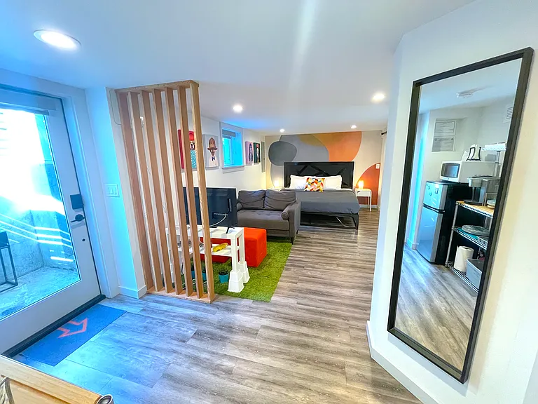 Daylight basement third bedroom. It includes a sitting area, kitchenette, and separate entrance.