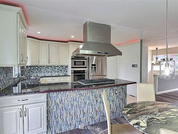 Custom mosaic backsplash and knee wall. Crown molding houses LED lighting that can change in color.