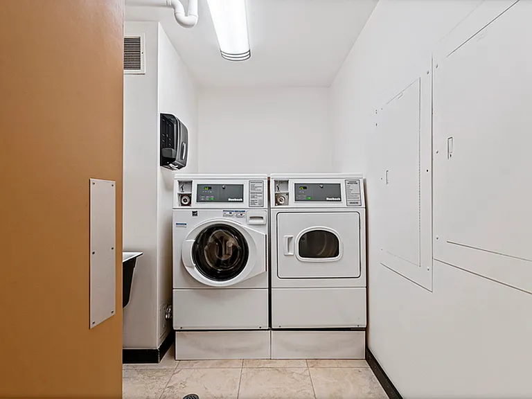 laundry room down the hall next to the elevator