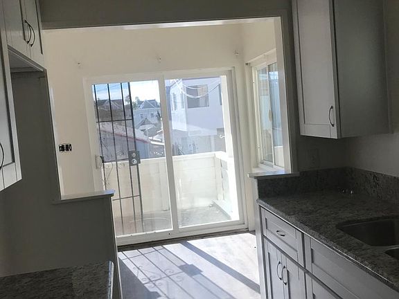 Upstairs kitchen leading to balcony