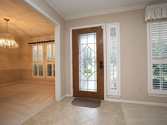 Come inside and take a look! Plantation shutters decorate the windows of the living room, dining room, kitchen, breakfast room and front bedrooms.