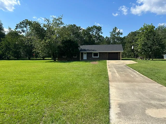 Brick ranch style home. Large 1 acre lot with a mature lemon tree. Flat land for easy gardening, mowing, etc. Concrete driveway. Fenced in back yard. Room for semi-parking. All new windows, roof, and single car garage door.