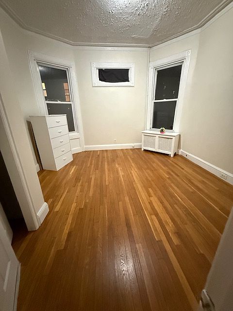 1st Bedroom, large room, hardwood floors, 2 windows, closet
