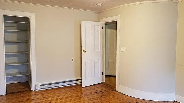 Bedroom 3 View 3. Shows curved wall and closet.