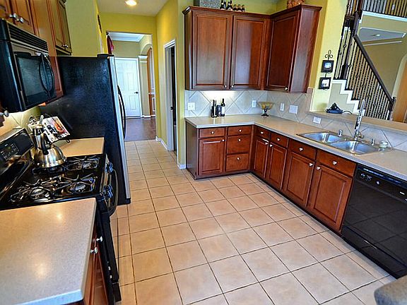 Kitchen has loads of 42-inch maple cabinets, with under-cabinet Counter lighting, Corian Counters, t