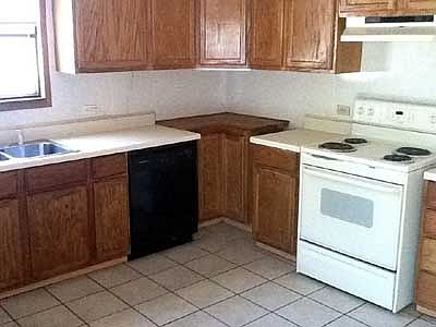 Kitchen with appliances and tile floor