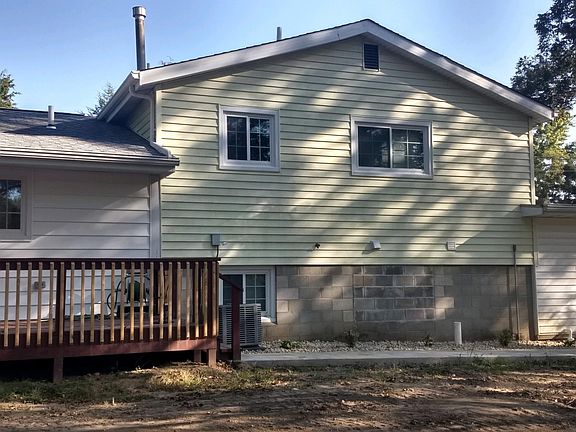 LARGE REAR DECK WITH CONCRETE SIDEWALK. SIT ON THE DECK AND ENJOY THE VIEW.