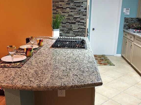 Spacious island with new white paint replacing the coper colored pain. East access to garage to unload car easily.