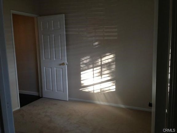 2nd bedroom with lots of great light, new carpet and plantation