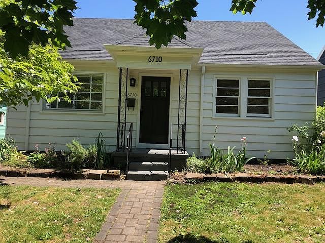 Front of house--driveway to the left with parking