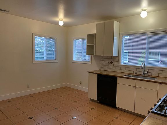 Kitchen & eating area (note: washer and dryer are to the right) door to backyard is to the left of photo.