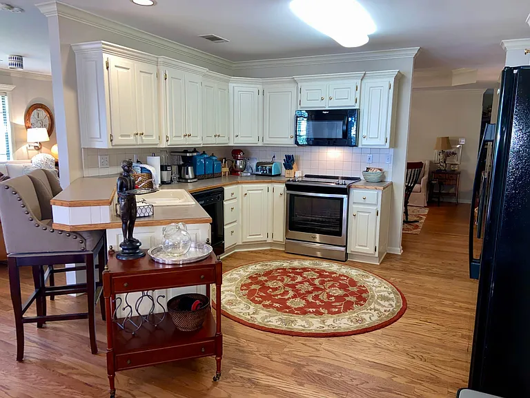 Stocked Kitchen with built in buffet and desk across from it
