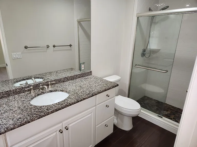 Maaster bathroom, walk-in shower with glass doors, tile floors, granite top