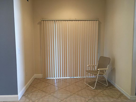As you enter the open plan Kitchen/Family room you find a separate eating area. Behind the curtain is a screened in porch.