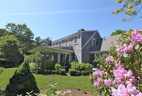 Welcome to 1 Granny's Lane. This view of the rear facade shows the original dormered Cape with a wing at right for the master bedroom suite and a glassed sunroom projection to the left.