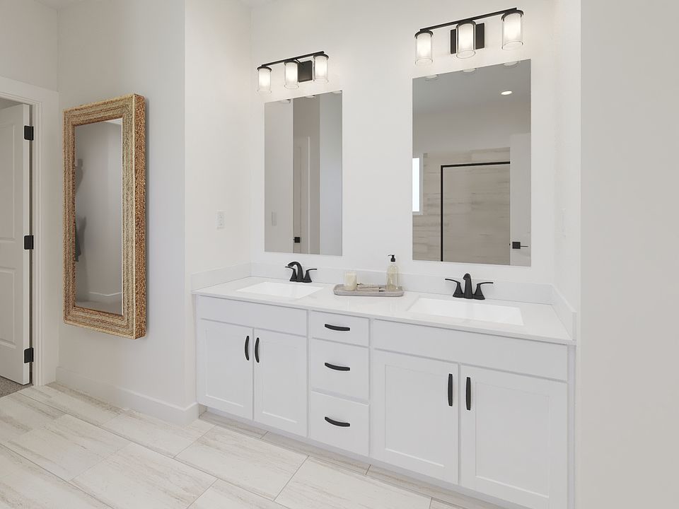 The primary bathroom offers dual vanity sinks and a walk-in shower.