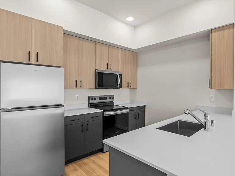 Cook and entertain with ease in a modern kitchen complete with stainless steel appliances, sleek finishes, and ample counter space.