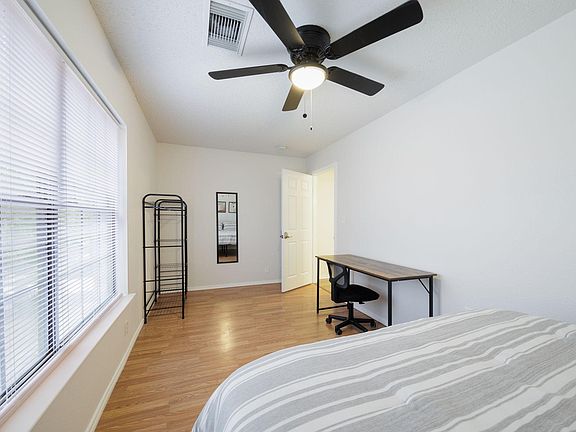 Ceiling fan, desk, and wardrobe included.