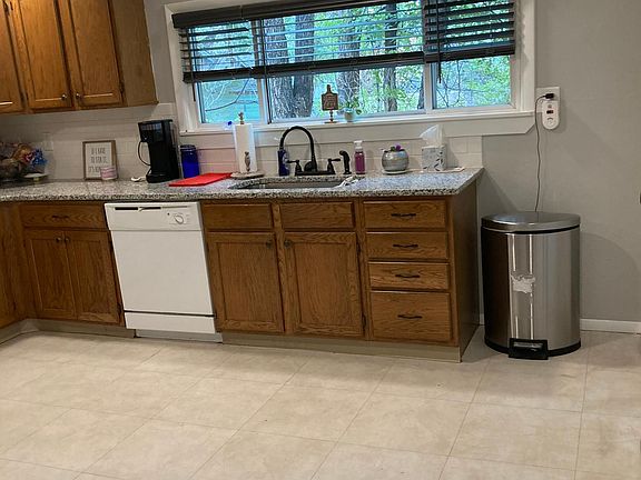 Large Kitchen-new granite counters, recessed lights. windows with view of trees. New dishwasher