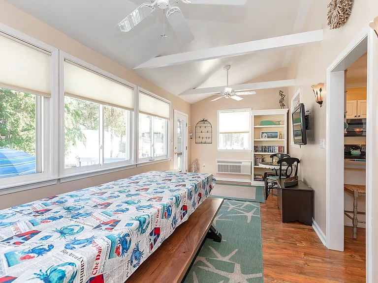 Entertain guests in this bonus room overlooking the backyard. Provided is a long table perfect for gatherings.