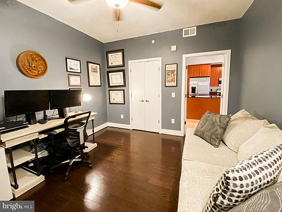 View from second room, looking into the kitchen. Unit door immediately to the left after going out of the pictured door.