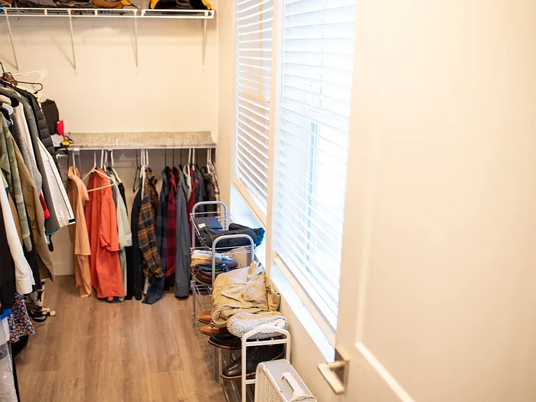 Primary walk in closet with beautiful windows for light