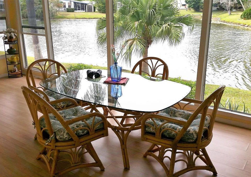 Fully glassed in lanai. Table with seating for 6 and a love seat.