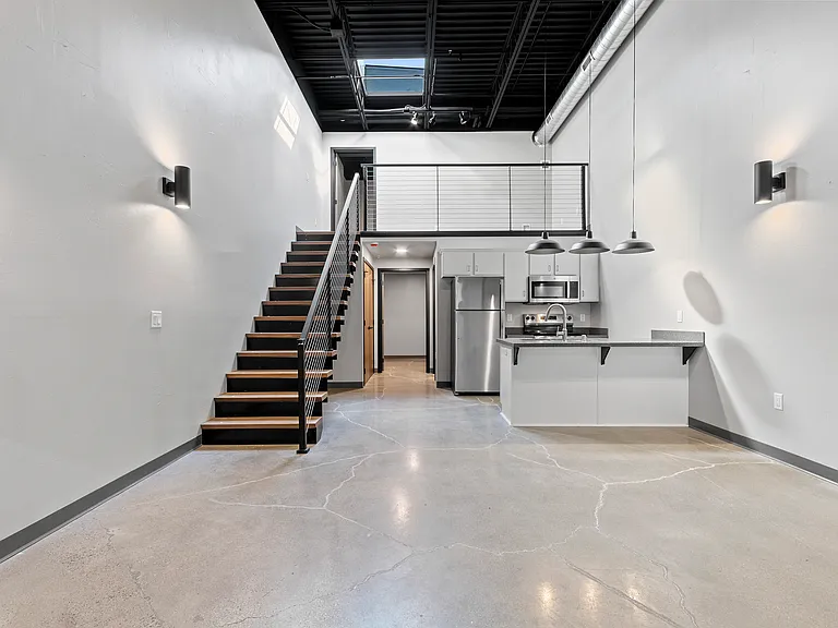 Welcome to this bright & spacious 2-bed, 1-bath loft featuring an open-concept living room and kitchen with stainless steel appliances & durable hard surface countertops. Enjoy the unique cable railing loft that serves as a dedicated at-home workspace...