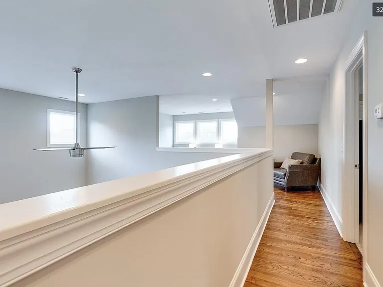 Second floor hallway leading to 3 bedrooms and full bath