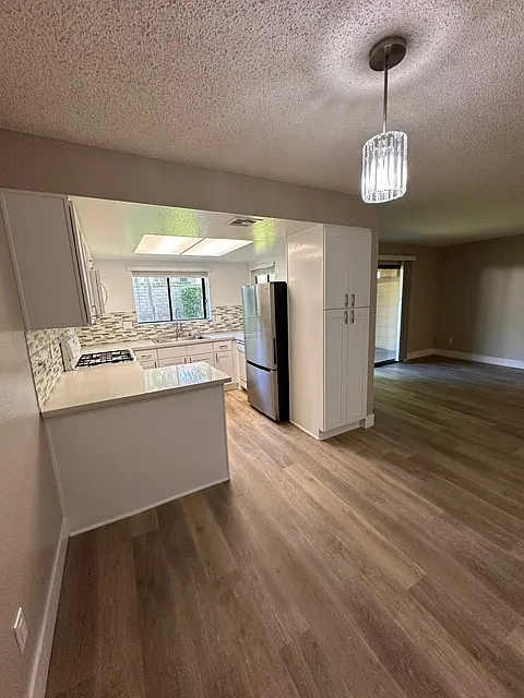Dining room view into kitchen - 8316 Vineyard Ave #D