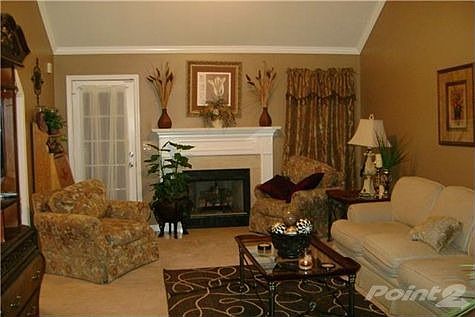 Living room with vaulted ceilings, crown molding and gas fireplace