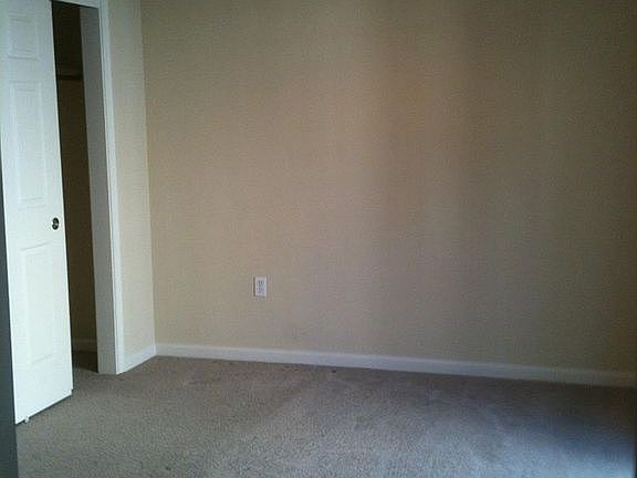 Downstairs carpeted bedroom with ceiling fan/light and large