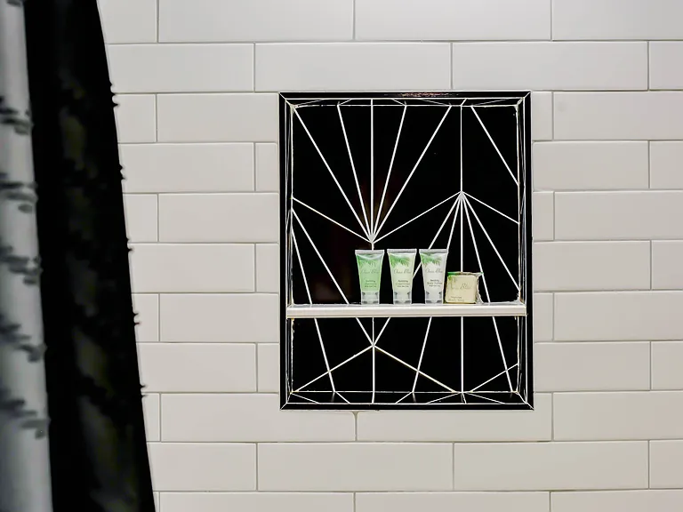 The beautifully tiled bathroom adds a touch of character and style, creating an inviting space that's both impressive for guests and enjoyable for everyday use.