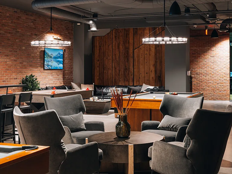 Community game room featuring billiards, ping pong, air hockey, pinball, a bar area, and virtual golf simulator